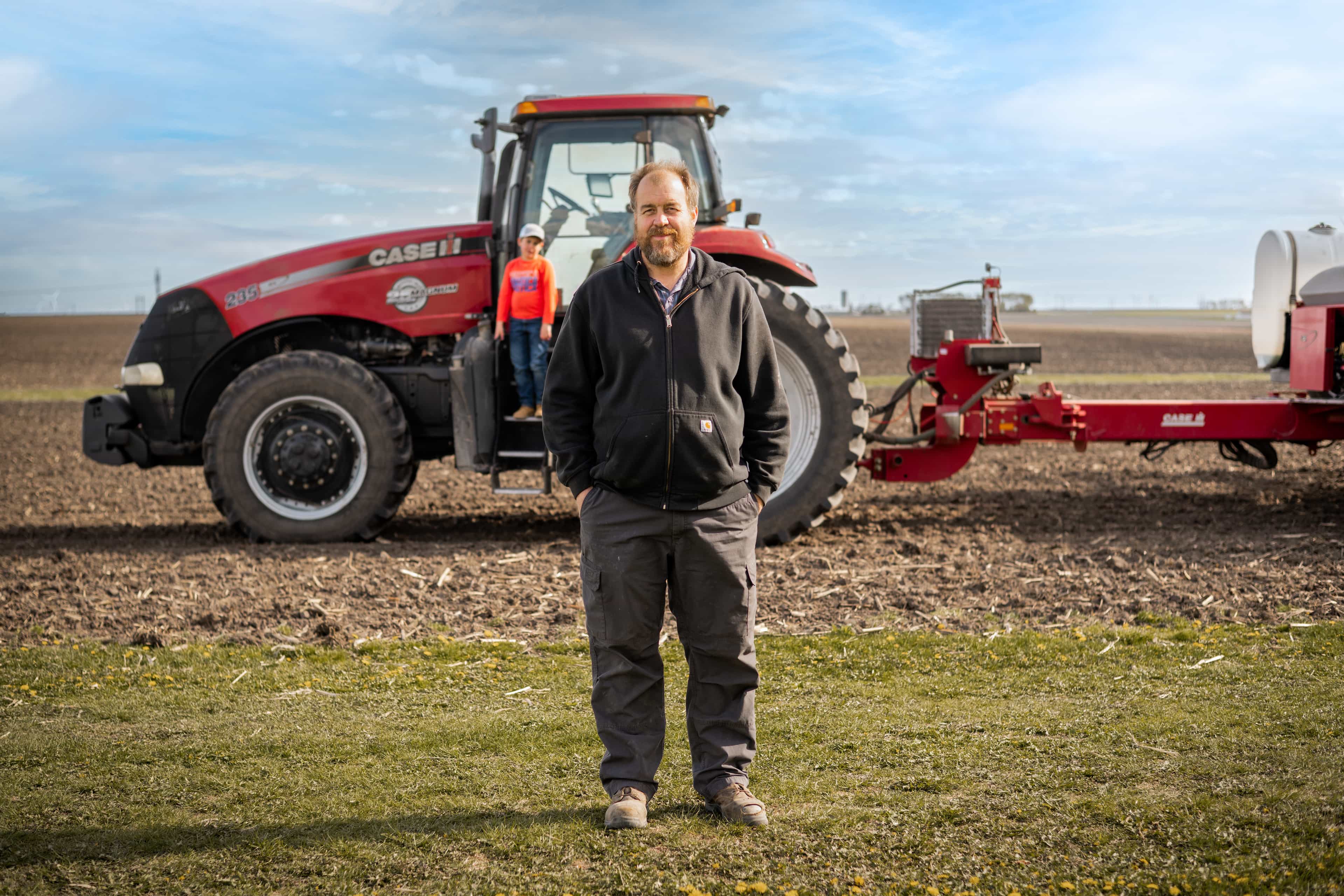 Image of Justin Gerber in front of a tractor