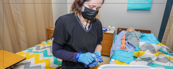 Nursing student practicing patient care in a clinical lab