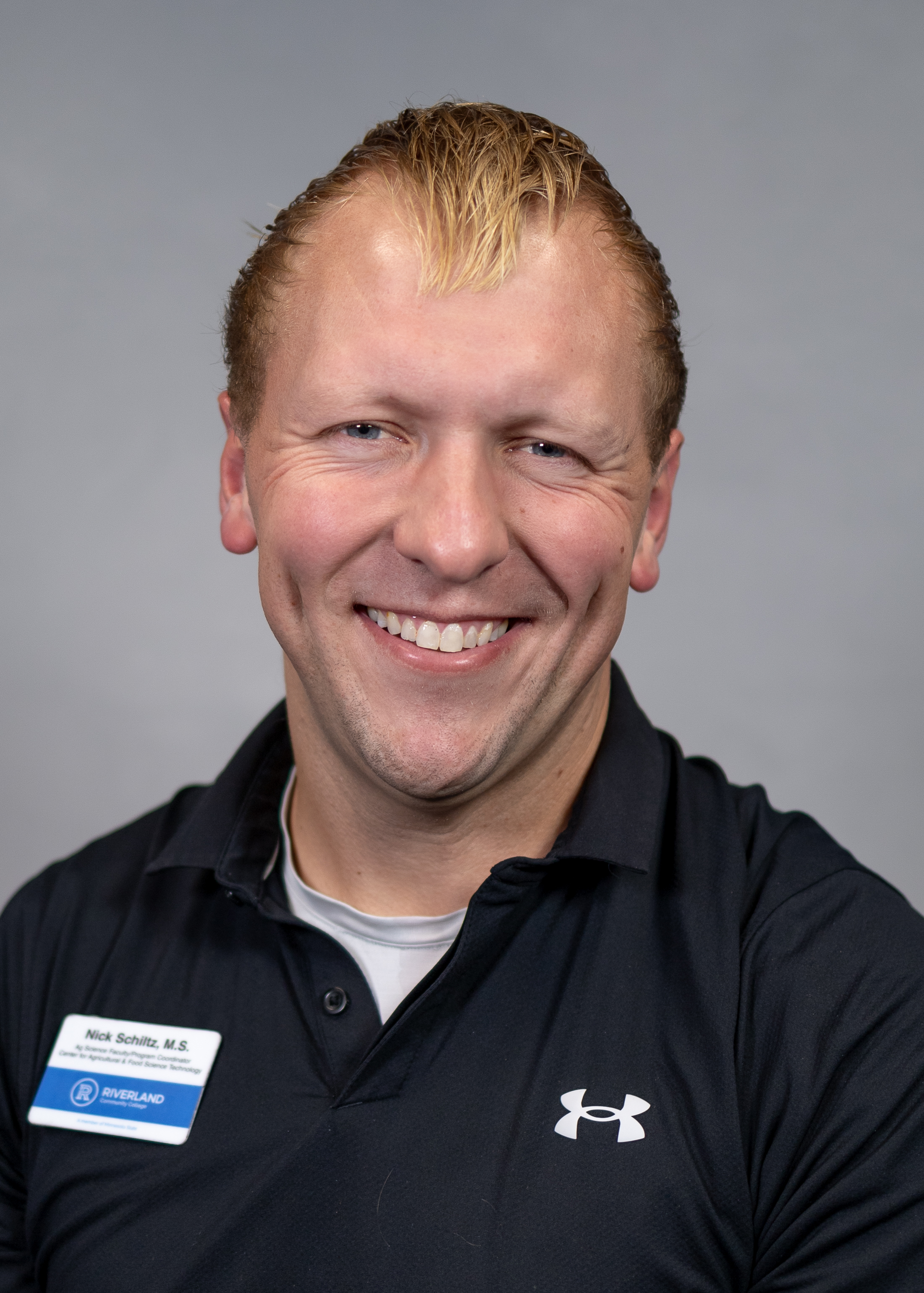 Photo Nick Schlitz wearing a black shirt, smiling